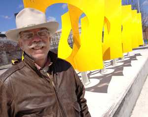 jon hudson with large fluid dynamics sculpture in Dayton, OH